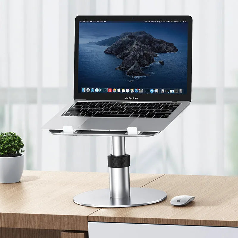 Silver adjustable aluminium laptop stand raised to mid-height with ventilation holes visible.