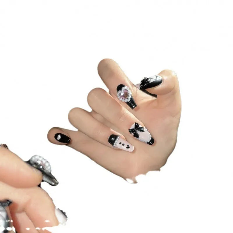 Black and pink peach heart hand-painted artificial nails with bow patterns in cat's eye finish