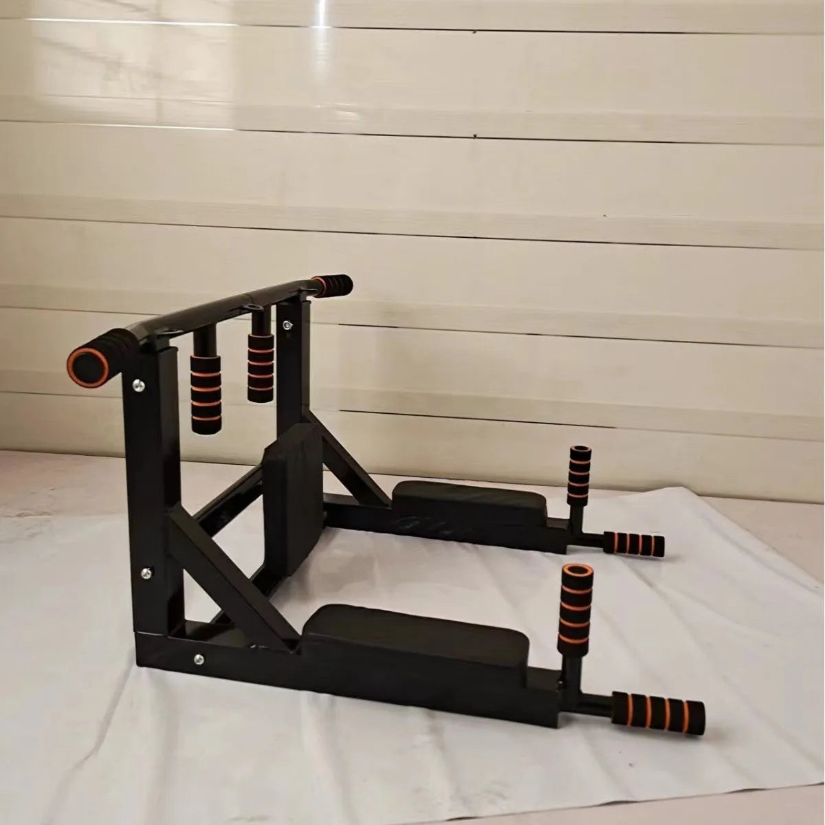 Black wall-mounted fitness rack with sandbag holder and single parallel bars for strength training
