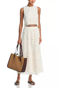 White women's sleeveless top and long skirt suit with retro embroidery details