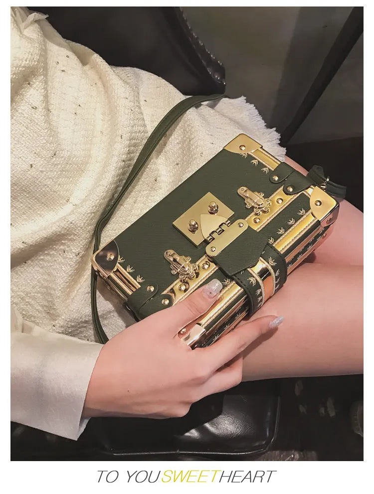 Women's hard frame shoulder bag in black or green with single adjustable strap and flap closure
