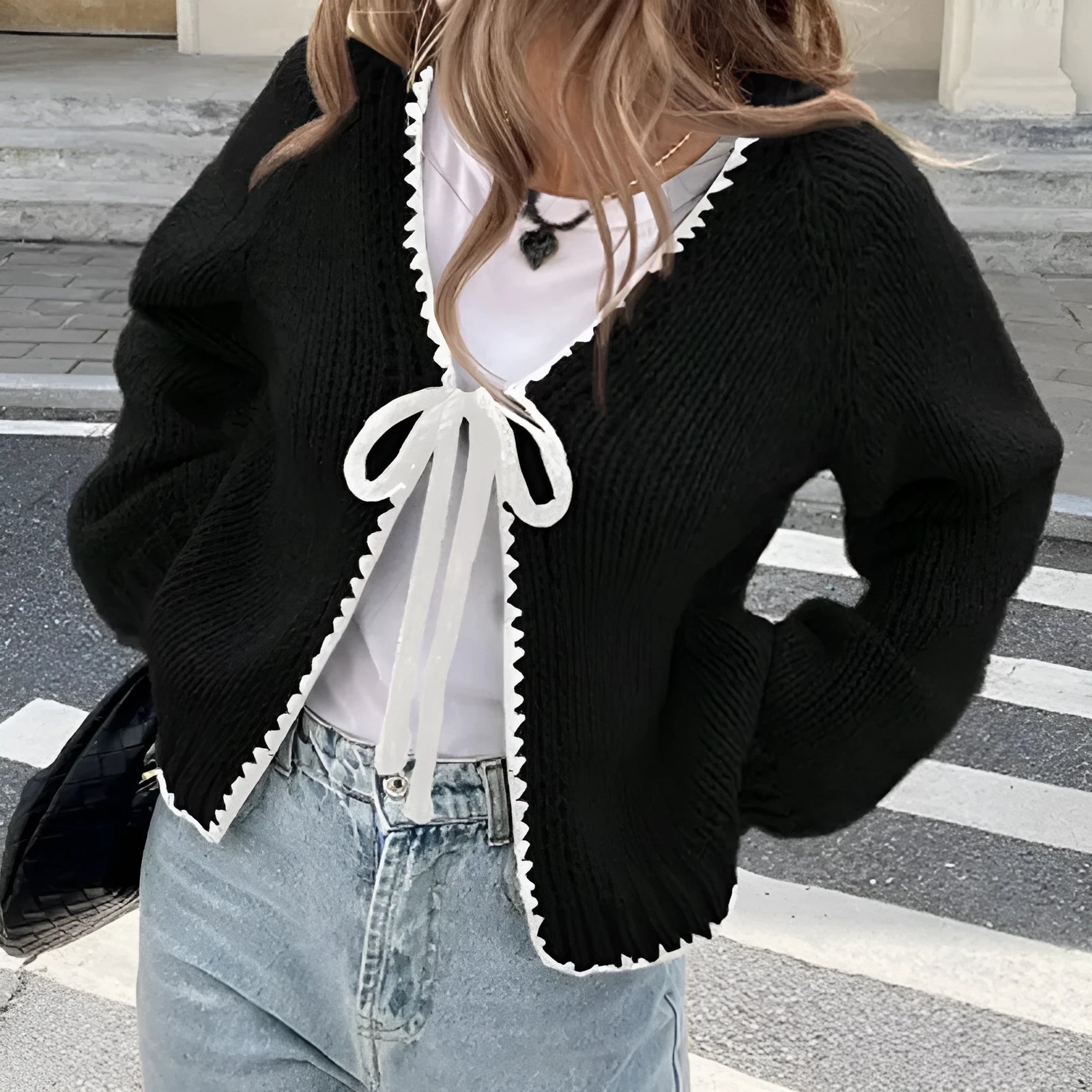 Lace-up front cardigan sweater with crocheted flower detail in solid colour
