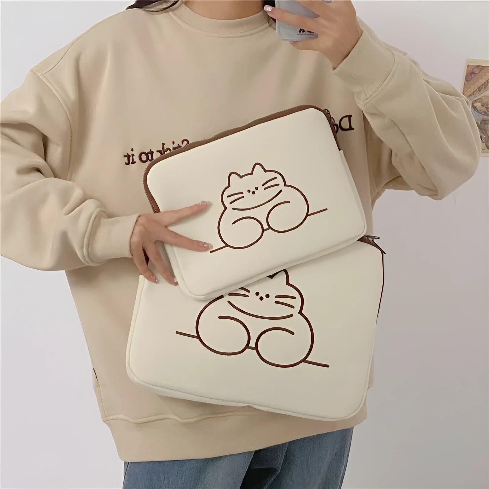 Nylon tablet protective sleeve with embroidered cat design and zipper closure
