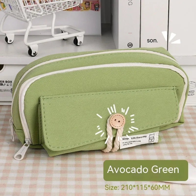 Canvas button-closure pencil case in beige, shown open with pens inside, demonstrating its large capacity.
