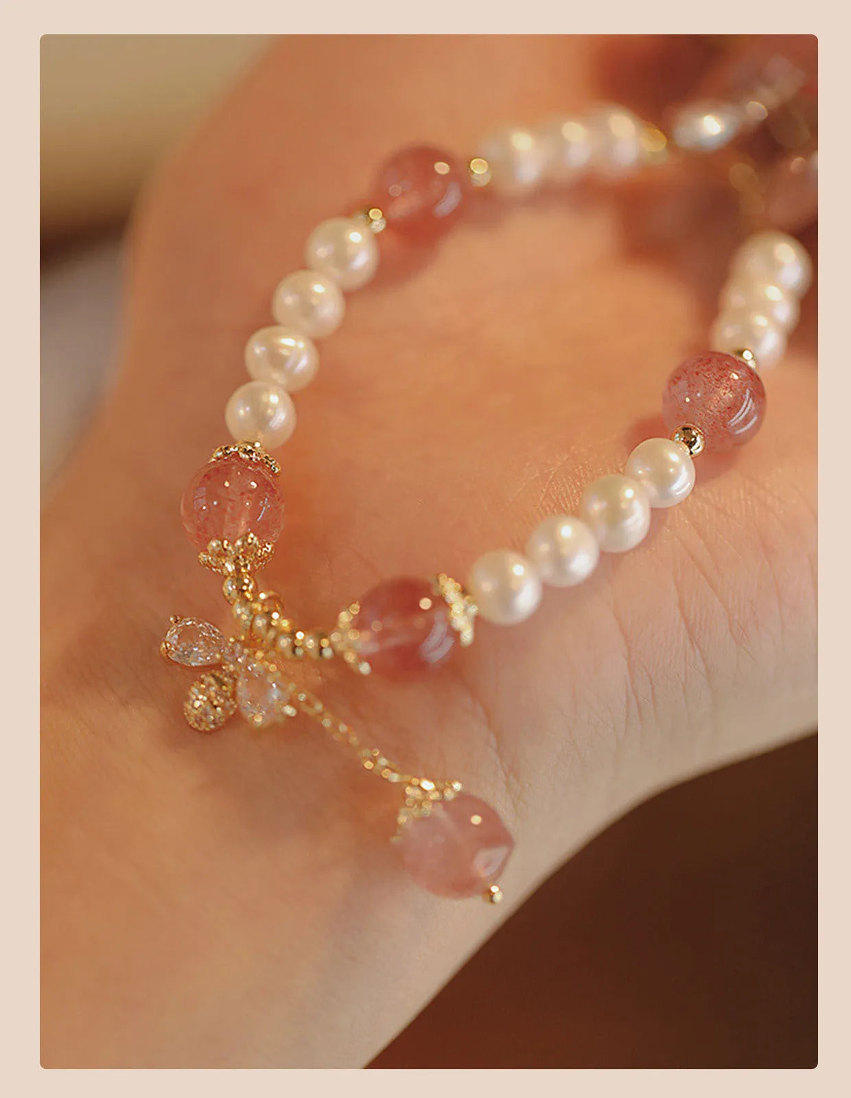 INS style women's crystal bracelet with strawberry quartz stones and a central bow detail.