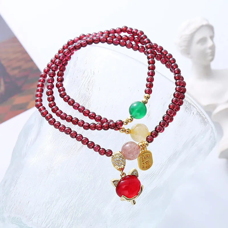 Purplish red garnet crystal fox charm bracelet with adjustable rope design