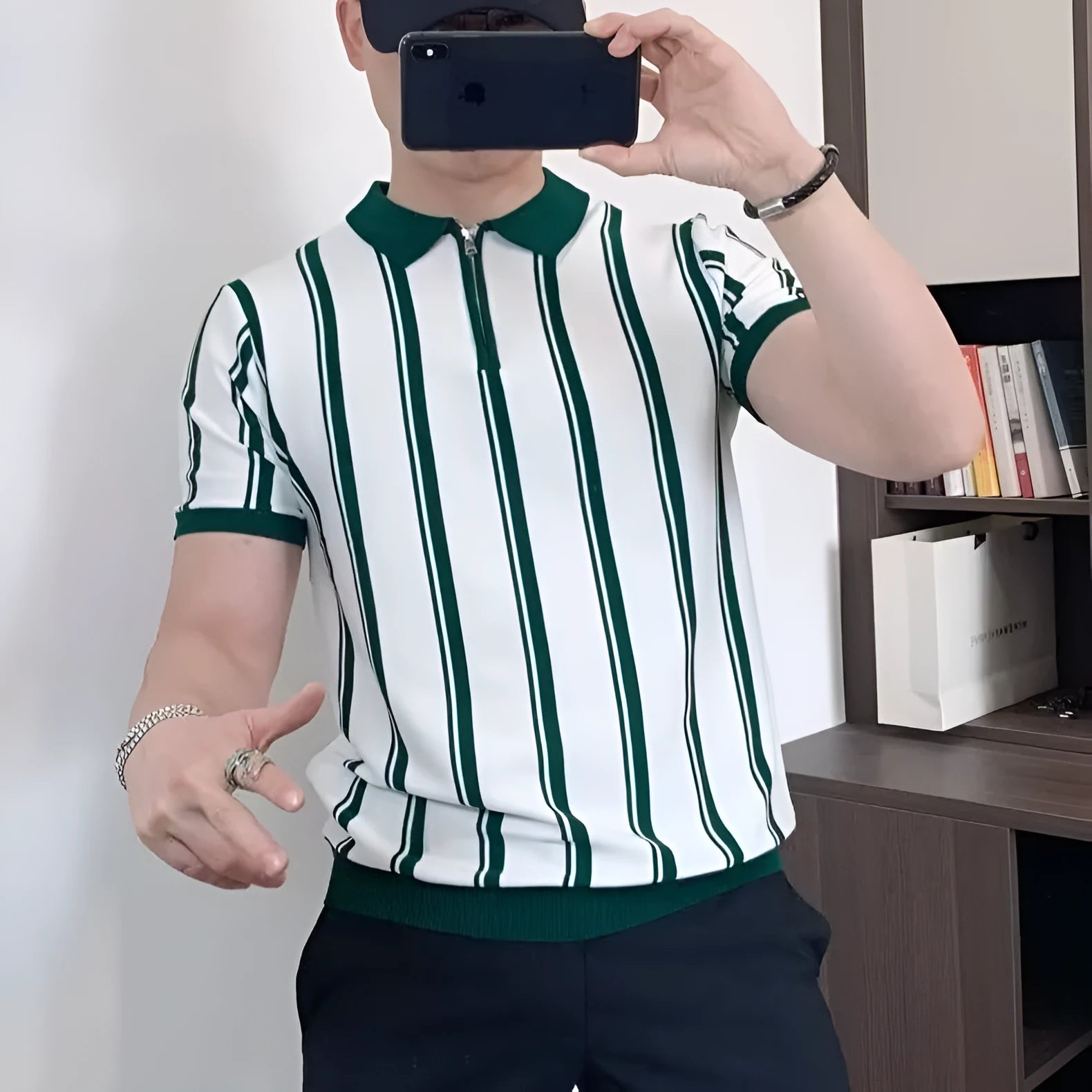 Man wearing a black vintage stripe t-shirt with a cartoon print and a zip detail on the half sleeve.