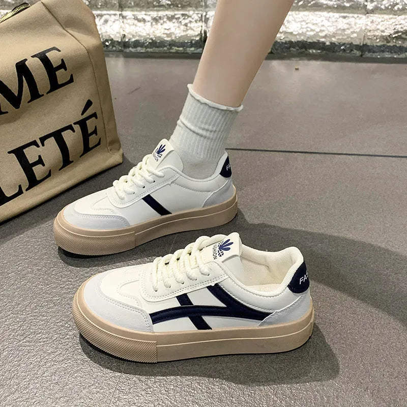 Classic brown and blue low-top casual trainers with flat rubber sole and lace-up front.