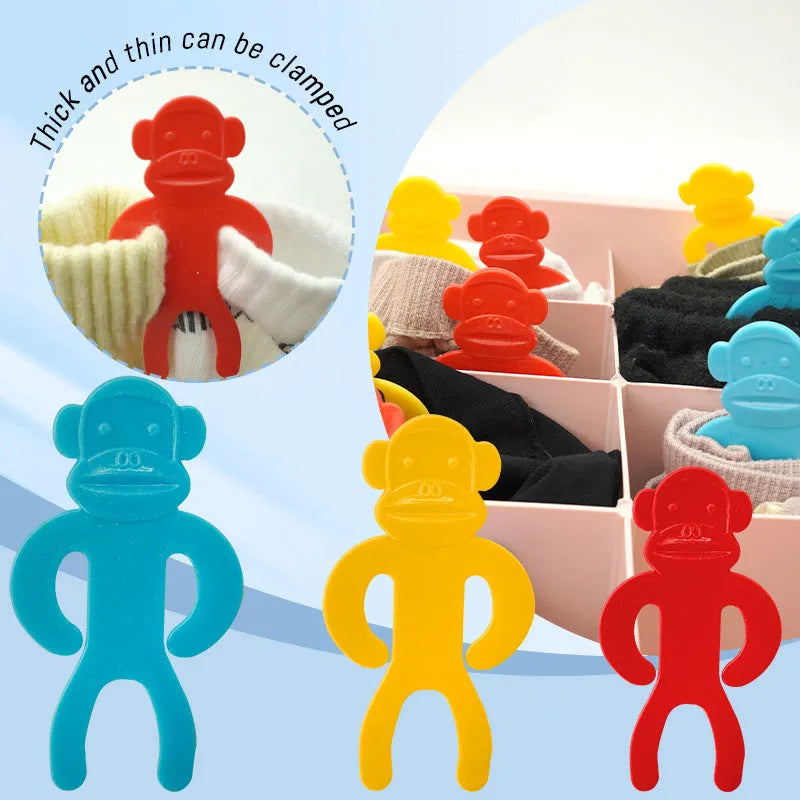 Plastic socks clips in blue, yellow, and red colours for laundry organisation