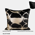 Black and gold abstract pattern flannel pillow cover on a grey sofa.