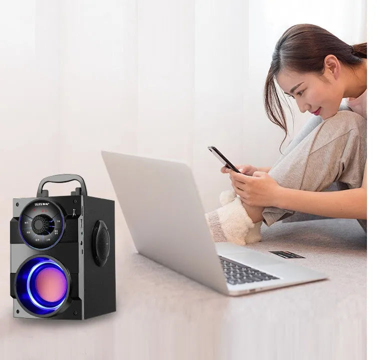 Black portable mini audio system with subwoofer, connection cable, and charging accessories