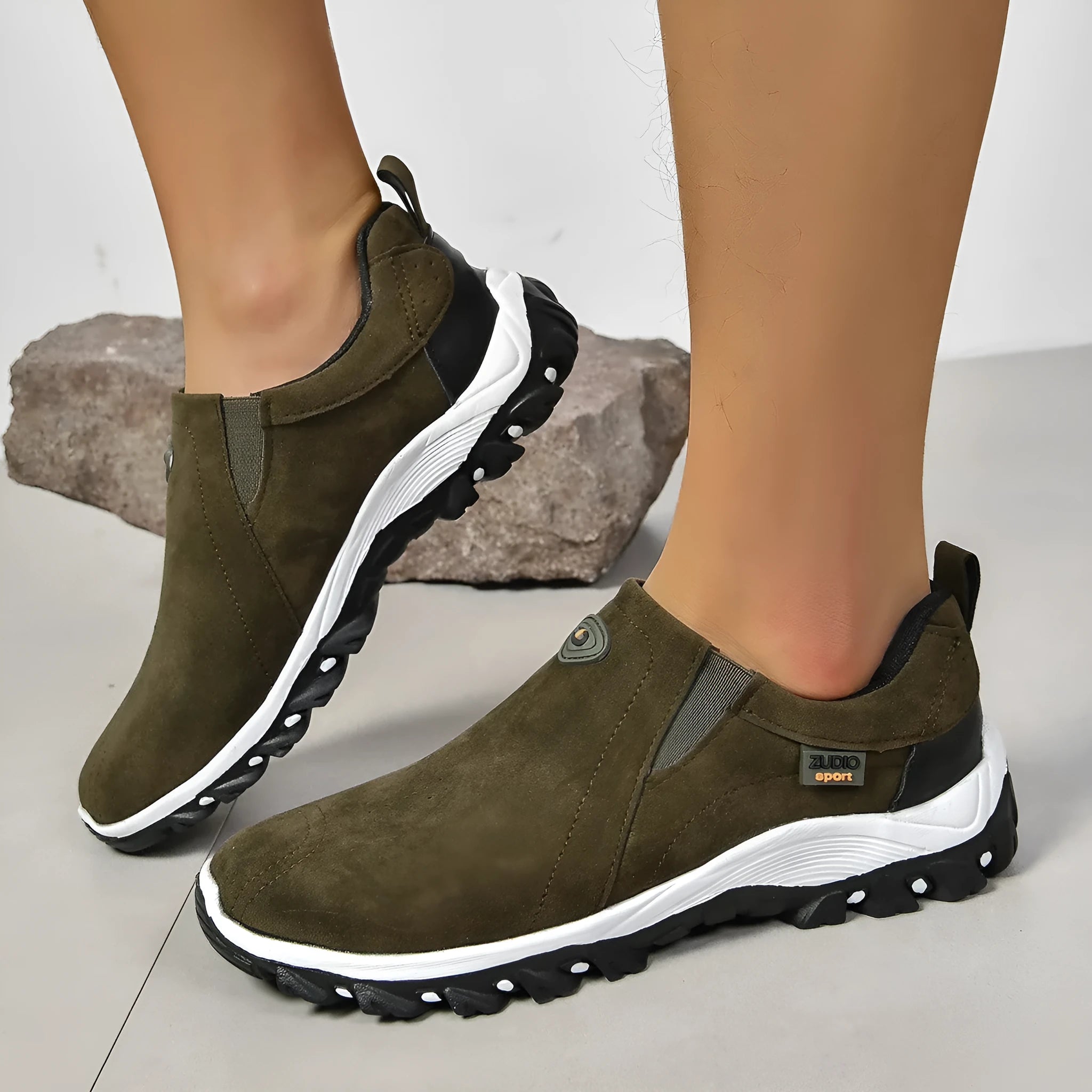 Men's gray round toe slip-on casual shoes with a rubber sole on a plain background.