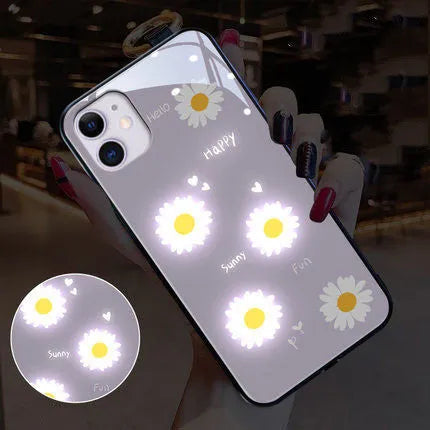 Luminous phone case for iPhone with voice-activated colour light showing painted daisy design on white TPU material