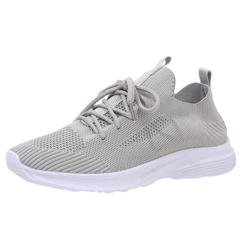 Women's low-top running shoes in creamy white with mesh and Flyknit breathable upper.