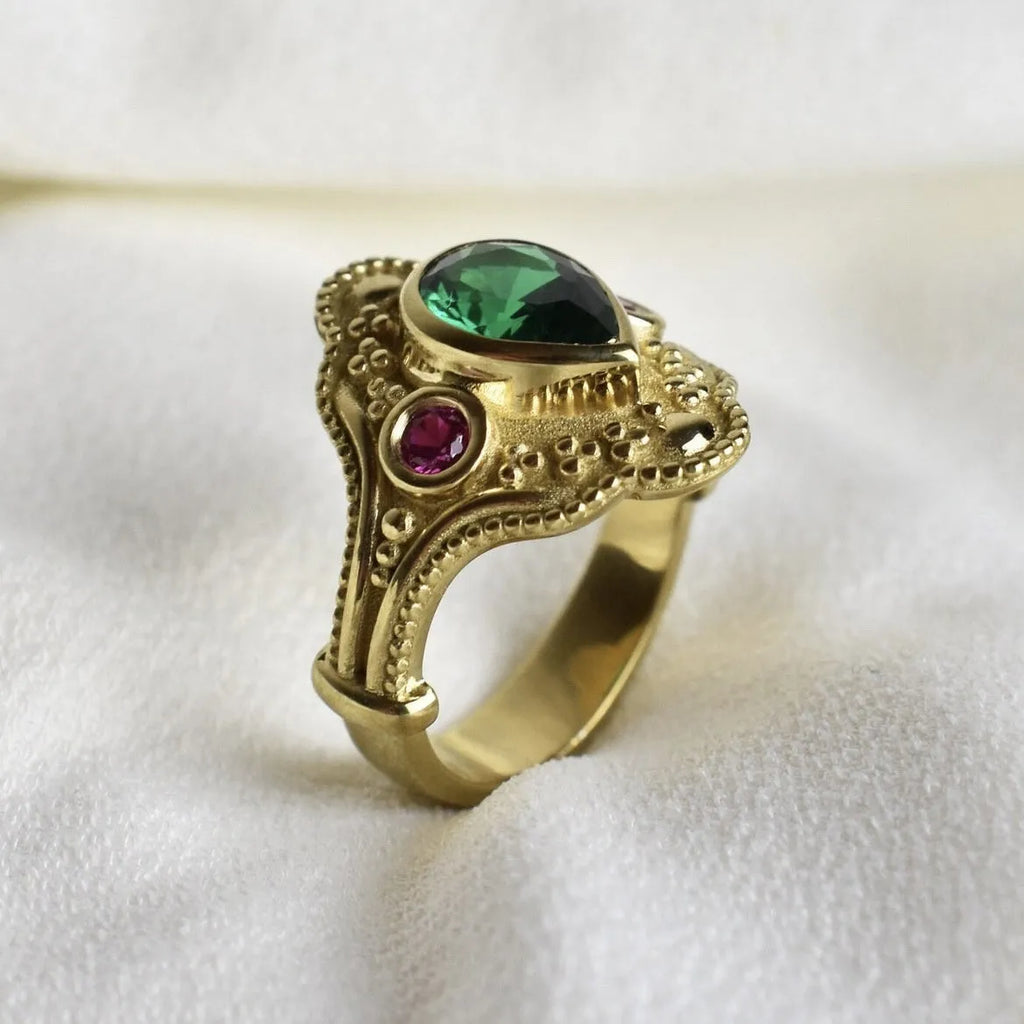 Gold-plated women's ring with geometric design and golden lvzuan colour on a white background.
