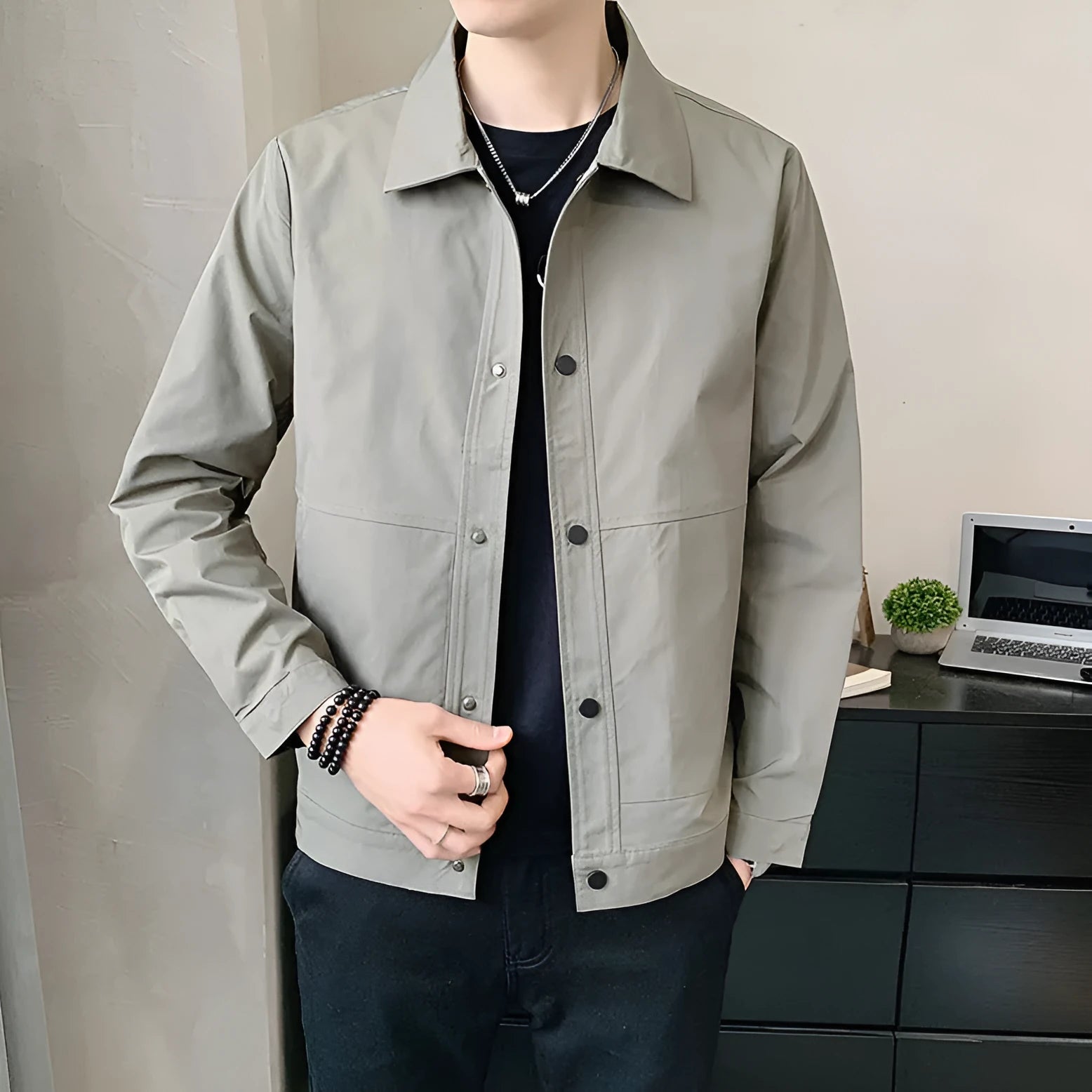 Man wearing a Korean style lightweight single-layer jacket in grey, showing front zip and long sleeves.