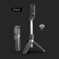 Black extendable Bluetooth selfie stick tripod with wireless remote next to a smartphone