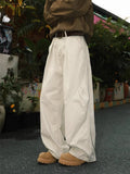 Men's pleated straight leg trousers in stripe patterns showing loose fit and micro elastic fabric