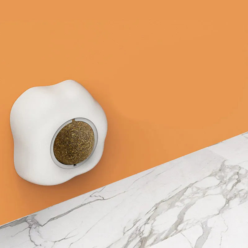 Interactive catnip ball toy with 360 rotation mounted on wall for feline teeth cleaning play