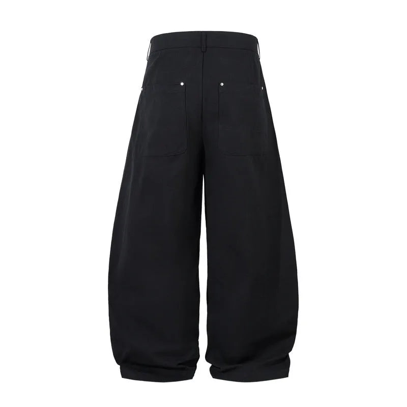 Men's black cotton trousers with pleated machete detailing and loose-fitting wide-leg silhouette