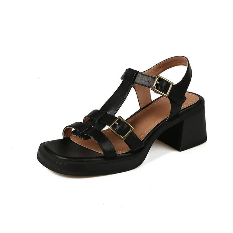 Women's black retro platform sandals with a T-shaped buckle strap and chunky heel.