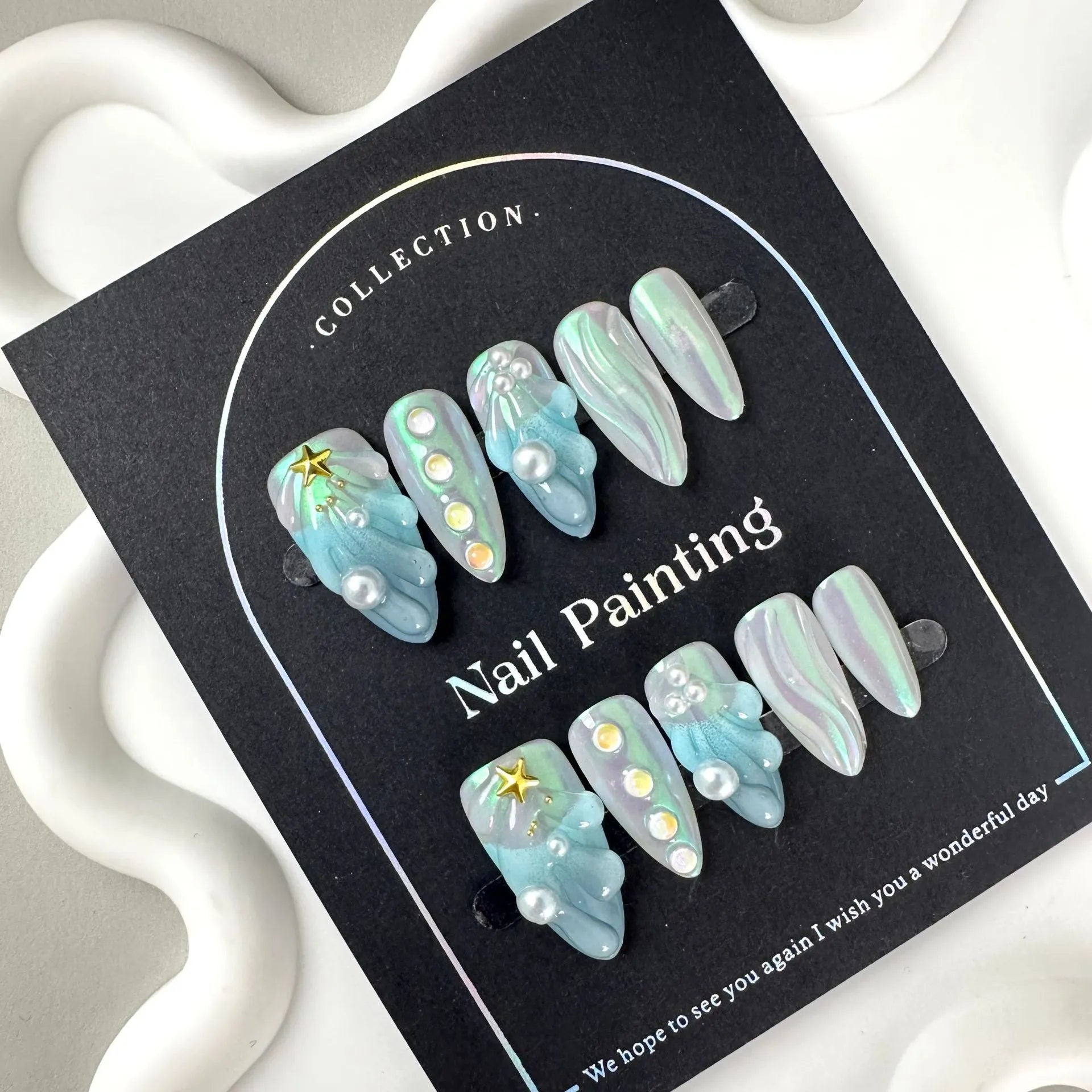 Blue summer design plastic false nail stickers in XS, S, M, L sizes.