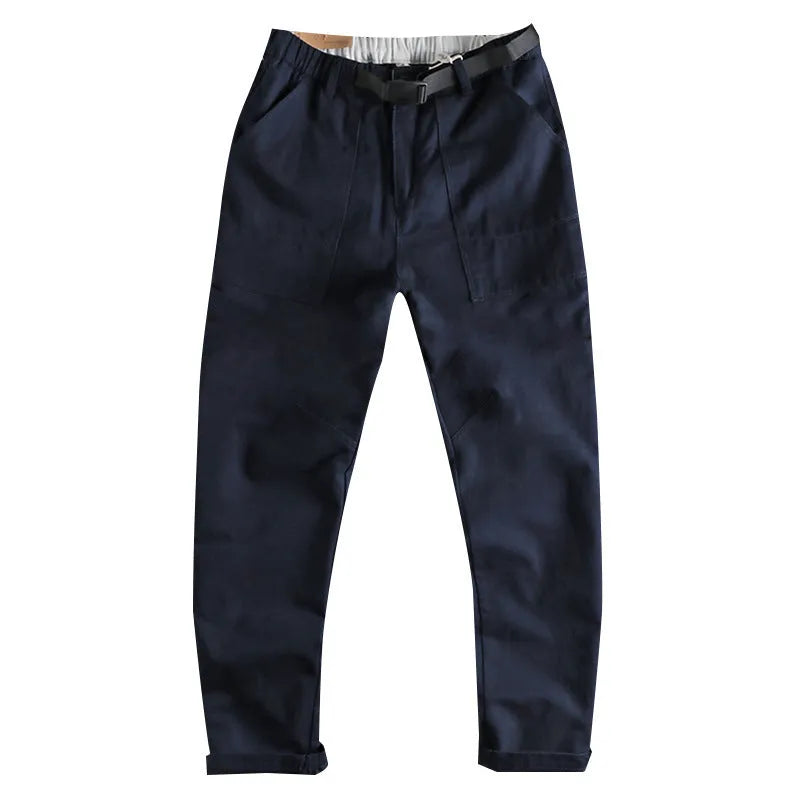 Men's khaki cotton work trousers with a matching N I buckle belt, showing three-dimensional cutting and a zipper fly.