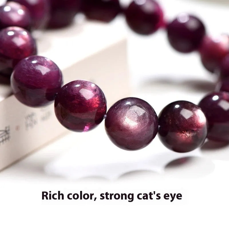 Purple lepidolite polished crystal round bead bracelet on a wrist, showing single circle design.