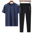 Men's ice silk quick-drying two-piece suit in white top and black trousers, model standing, solid colour casual wear