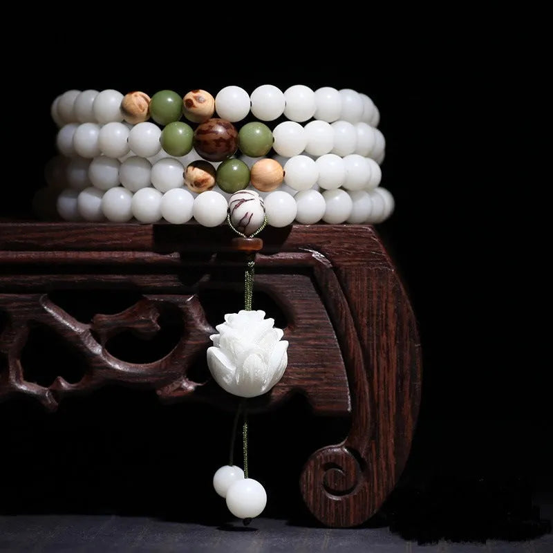 White jade Bodhi beads bracelet with 6x8mm beads in a choice of cloisonne, lotus, and tassel styles.