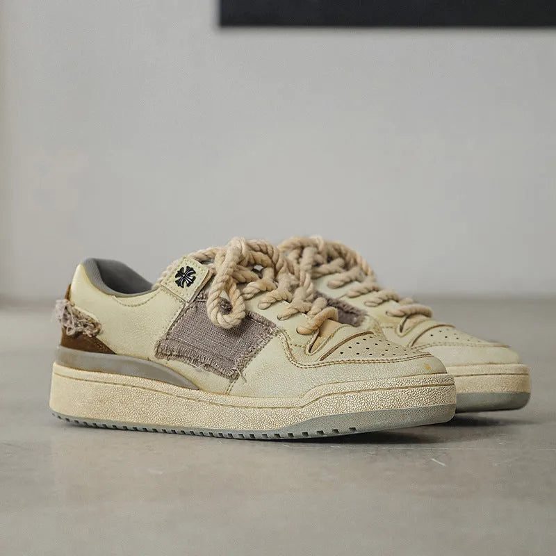 Beige low-top skateboard shoes with microfiber upper and rubber sole on white background