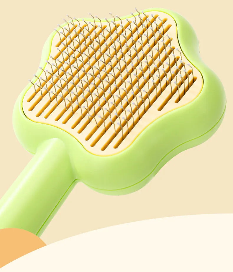 Green and yellow self-cleaning stainless steel cat comb grooming tool measuring 20 cm.