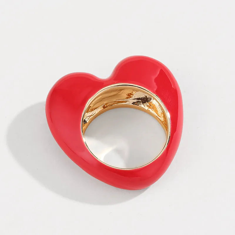 Close-up of a heart-shaped zinc alloy ring with three-dimensional pink enamel decoration.