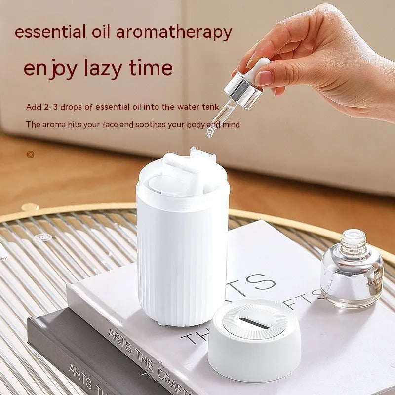Car aroma diffuser with simulated flame effect showing black unit with mist output