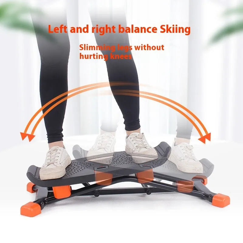 Black foldable mini fitness skiing machine JS101A with elastic hand straps on a home floor.