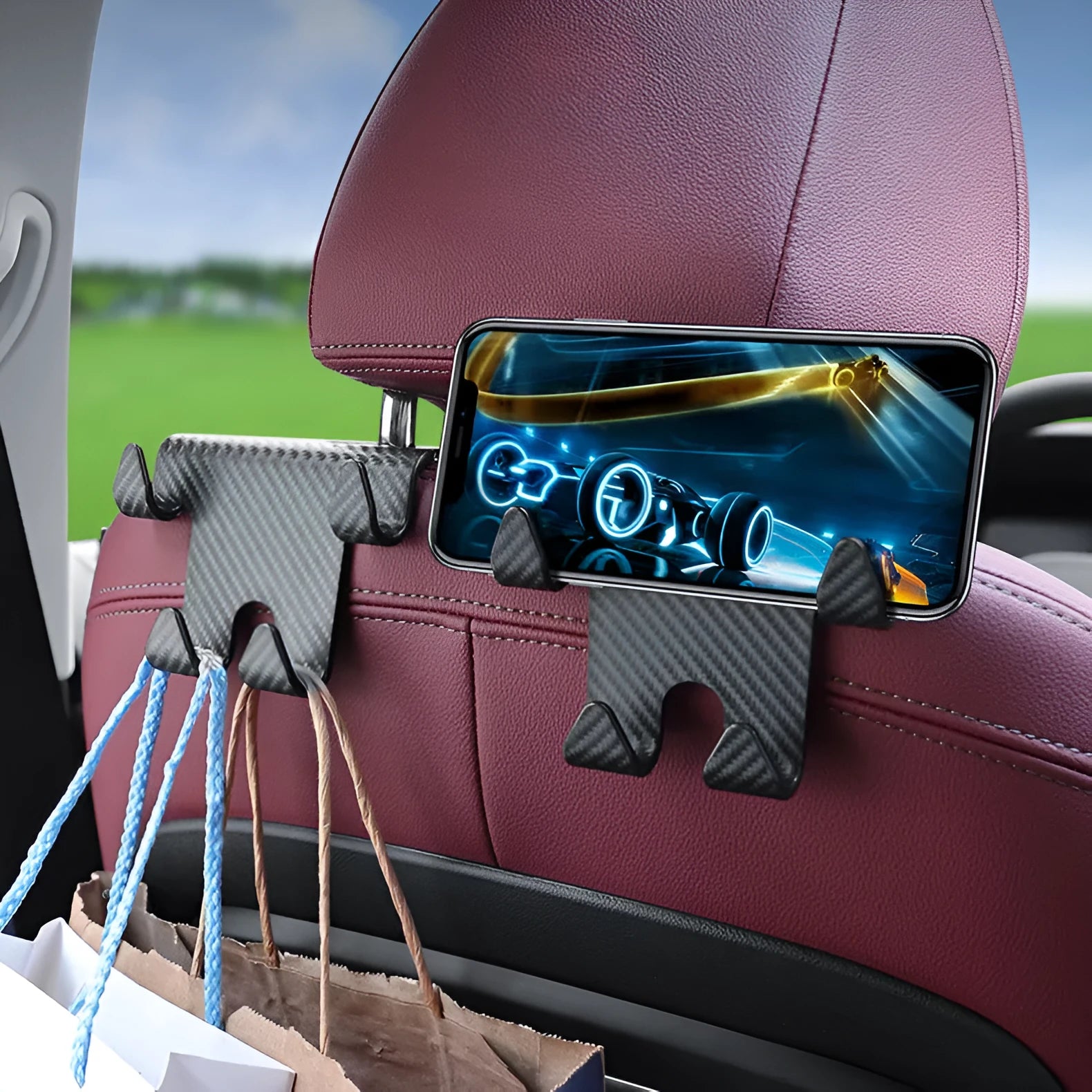 Black ABS car storage hook with carbon fibre pattern, combining a bag hook and mobile phone holder for rear seat installation.