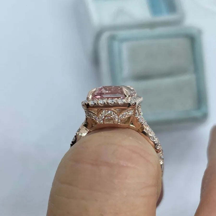 Geometric rose gold coloured alloy ring for women and men on a grey background.