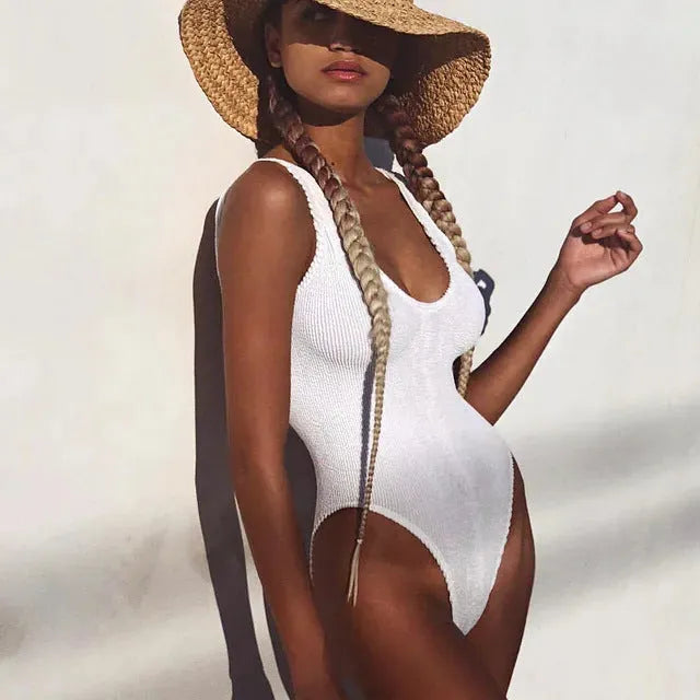 Women's solid colour one-piece swimsuit in seersucker bubble cloth fabric, backless and sleeveless design.