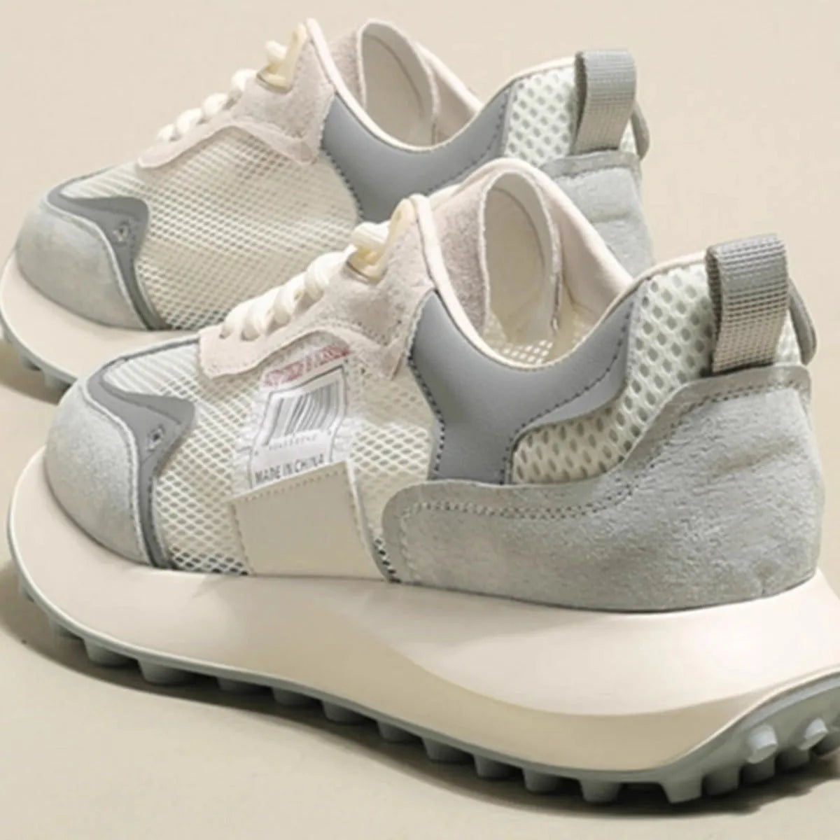 Women's grey and pink retro sneakers with low-top design and rubber sole