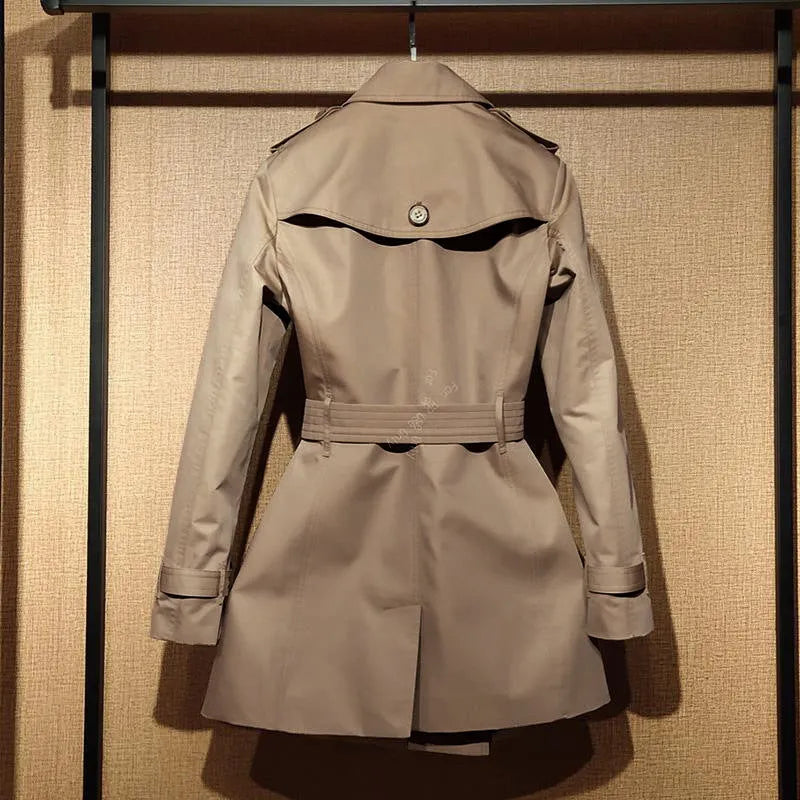 Khaki women's double breasted trench coat with flight sleeves and button detailing.