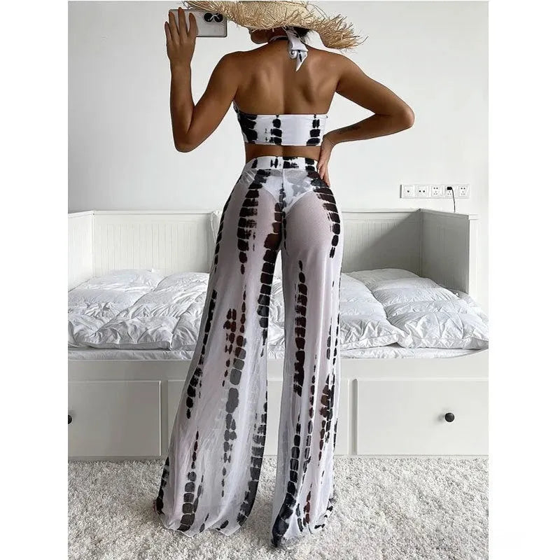 Adult female three-piece bikini swimsuit set with mesh trousers in black or blue printing.
