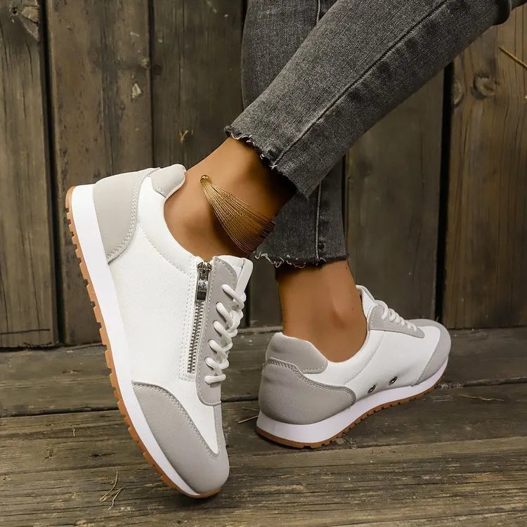 Women's flat shoe in artificial PU, rubber sole, shown in grey, white, or Champagne colour.