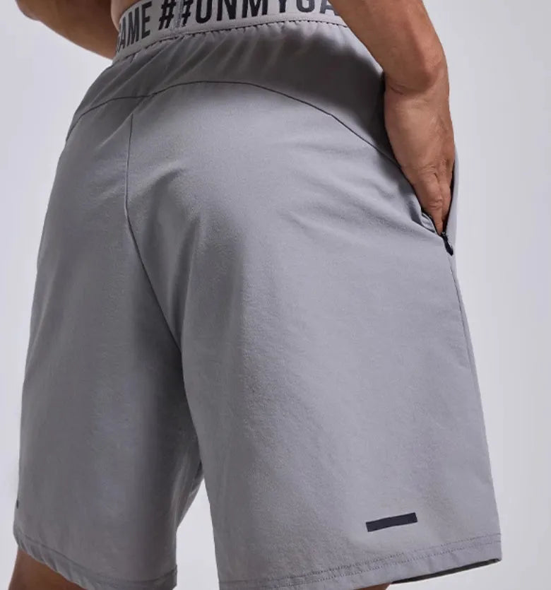 Men's loose black sports cropped shorts with elastic waistband and printed letter detailing
