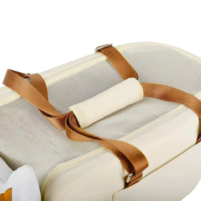 Beige hard-shell pet flight case with one-shoulder strap for cats and small dogs