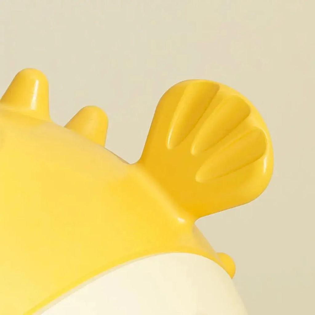 Yellow vinyl fish-shaped dog chew toy with textured surface for aggressive chewers