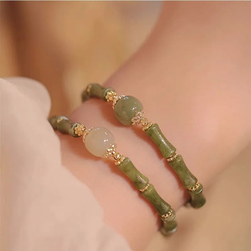 Hetian jade bracelet with geometric shape and round elements on female wrist