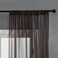 Pure colour cotton and linen vertical curtain in a modern simple style hanging on a window.
