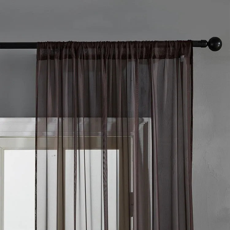 Pure colour cotton and linen vertical curtain in a modern simple style hanging on a window.