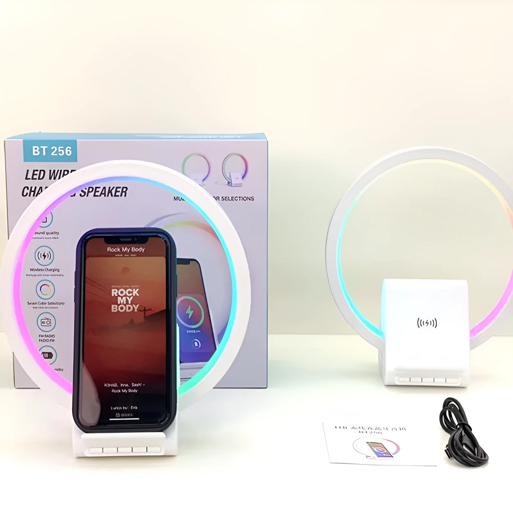 White smart Bluetooth speaker with ambient light and 15W wireless charging pad on desk
