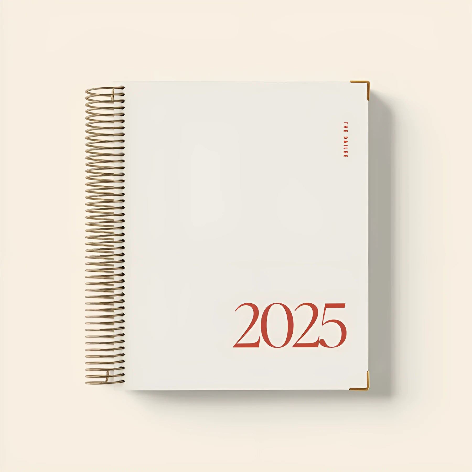 Cherry red coil notebook with spiral binding open to show flat-lying pages for writing